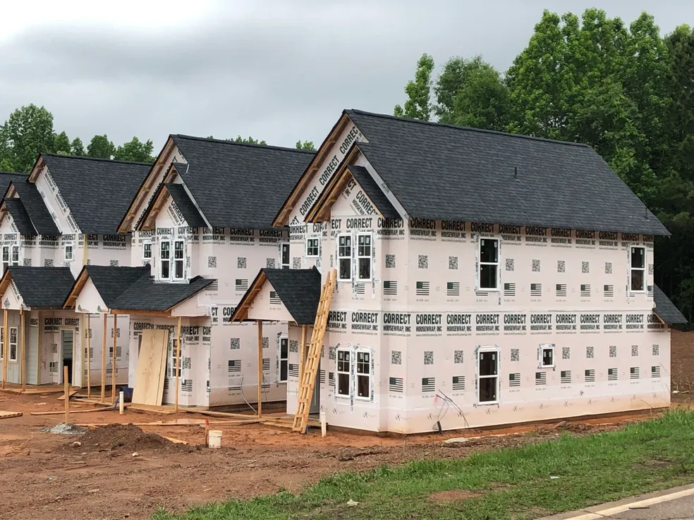 Professional housewrap installation in progress